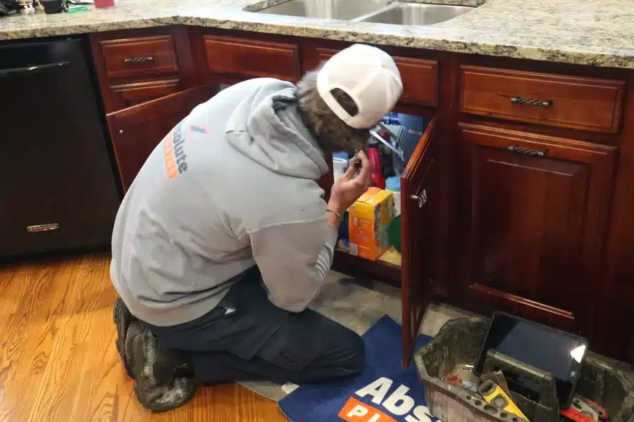 Plumber performing kitchen drain cleaning in Acworth, GA