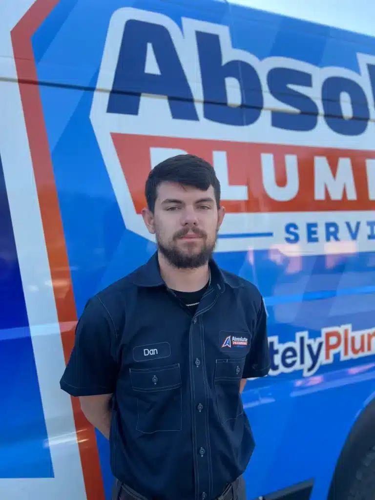 Plumber standing beside an Absolute Plumbing Services van in Acworth, GA