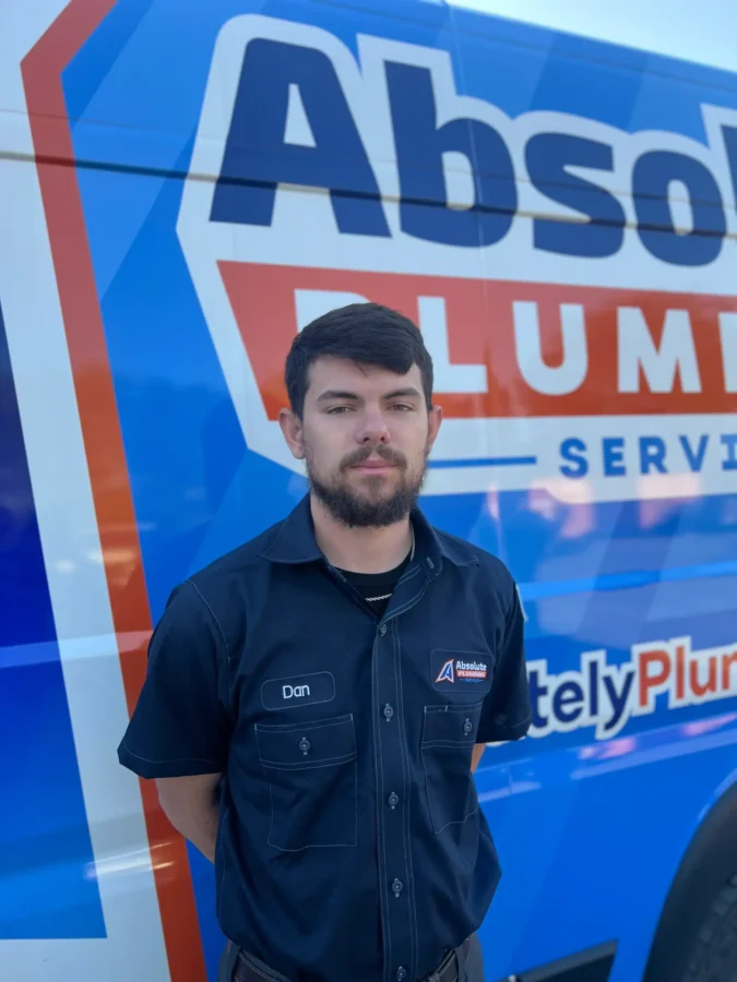 Plumber standing beside an Absolute Plumbing Services van in Acworth, GA