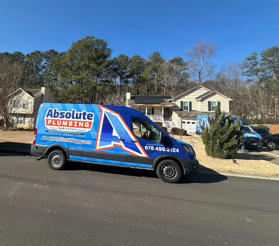 Absolute Pluming vans parked outside of a residential home in Acworth, GA