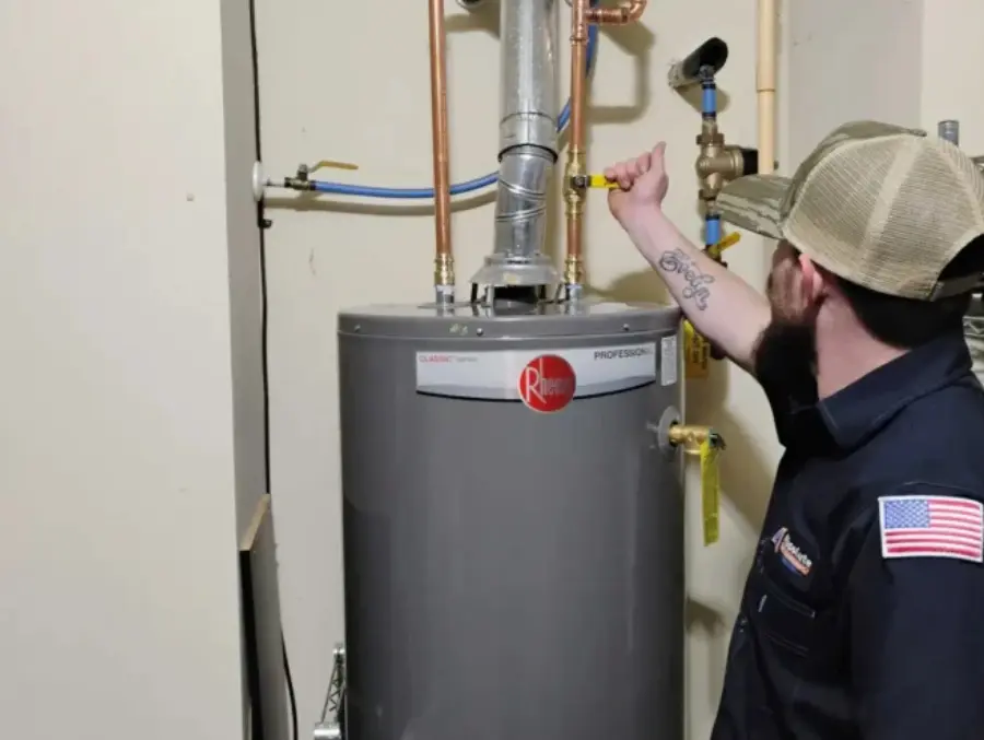 Absolute Plumbing Services plumber working on a Rheem Water Heater in Acworth, GA